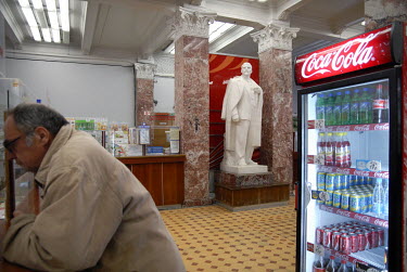 A Lenin statue and a Coca Cola branded fridge in a post office.