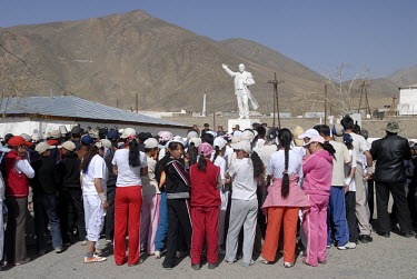 Youths gather in front of a Lenin monument for a speech at the opening of a regional sports tournament.