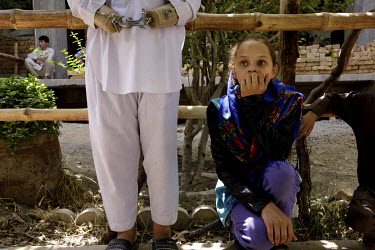 Madina (13) with Matiullaah, a young boy who lost his hands as the result of an electrocution, at ASCRCO (Afghanistan Street Children Relief Charity Organisation). Her father was badly injured in a mi...