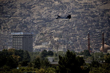 A military helicopter moves in to attack a position where ISIS terrorists are sheltering after launching an attackon the Presidential Palace and the Ministry of Defence.