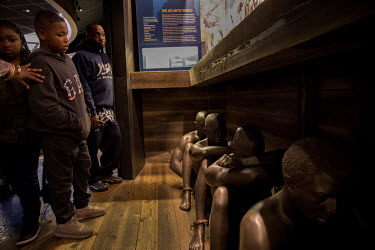 Visitors at the National Civil Rights Museum look at the museum's exhibits showing the history of the trans-Atlantic slave trade.