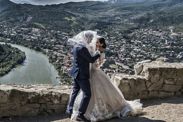 A couple bless their marriage with a kiss at the Jvari Monastery with its views over the Aragvi River.