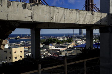 A view through the concrete structure of a building to the port.