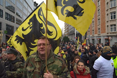 A man waves the flag of Flanders as a crowd, estimated at about 5000 people, held a rally against the UN migration pact signed a week before by a Belgian minority government. According to the Flemish...