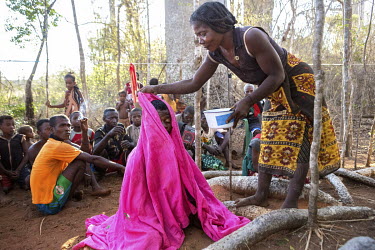 Takire (not in picture), a witch doctor from the Antandroi tribe, conducts a ceremony in a grove of baobab trees to cure young women of bad spirits.