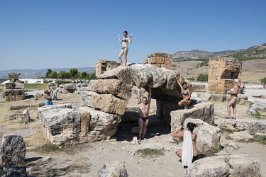 Russian tourists in swimsuits take photographs at the architectural remains of the Greco-Roman city of Hierapolis, near the Pamukkale hot springs. Hierapolis is an UNESCO World Heritage Site.