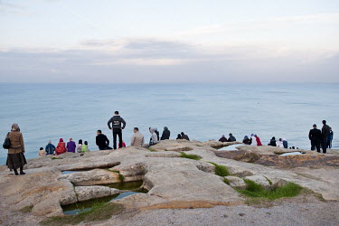 People watching the sunset over the Atlantic Ocean.