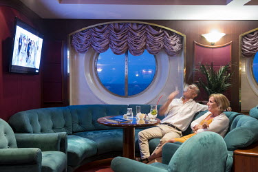 A couple smoke while watching television in the Lord Nelson Pub on board of the MSC Lirica, a cruise ship from the Mediterranean Shipping Company.