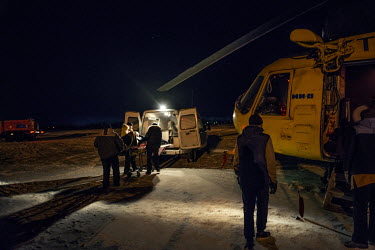 A patinet is loaded into an ambulance for the 10 minute drive to hospital after arriving on a helicopter at the airport.