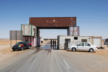 A military checkpoint made out of intermodal shipping containers, on the coastal highway between Sirte and Misrata.