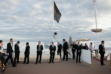 Security personnel at the 65th Cannes Film Festival guard the entrance to an area of exclusive beach bars along the Croisette, the pedestrian boulevard along the Mediterranean coast.