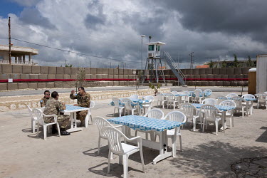 Italian UNIFIL soldiers relaxing ouside the restaurant in their compound, near the Israeli/Lebanese border.