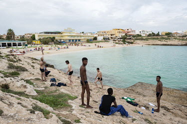 Newly arrived migrants from Syria and Somalia enjoy the sea near Guitgia Beach, just a few days after a boat disaster of 3 October 2013 when a boat carrying over 500 migrants, mostly from Eritrea, san...