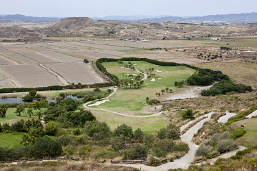 A golf course in a semi-desert landscape on the Mediterranean coast.