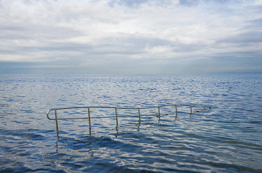 A metal rail to support disabled people as they enter the sea.