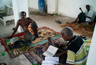 Olat, chewing khat, as he does each afternoon, while reading and taking notes.