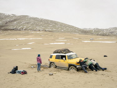 The four wheel drive vehicle transporting the expedition led by Yang Yong (geologist, environmentalist and the director of the Hengduan Mountain Research Institute) and photographer Ian Teh, gets stuc...