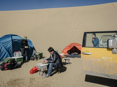 Independent Chinese geologist and activist, Yang Yong studies maps and sattelite images of the region near Rigecuo River, a subsidiary of the Yellow RIver, on his phone. Among the counties in the sour...