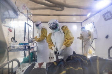 Doctors in personal protective equipment (PPE) treat a patient inside an a plastic Ebola treatment centre, run by The Alliance for International Medical Action (ALIMA) which can only be entered via a...