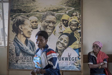 A woman walks past a poster of Dr Denis Mukwege in the Panzi hospital. The gynaecologist and surgeon is famous at home and abroad for his years of dedication to women who are victims of sexual violenc...