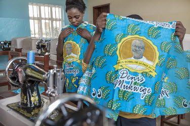 Young women in a studio, part of Dr Denis Mukwege's Panzi Foundation, making new clothes to celebrate the award of the Nobel Peace Prize to Dr Denis Mukwege. The fabric for the clothes is printed with...