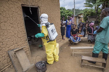 An Ebola response team wearing personal protective equipment (PPE) disinfect the home of a resident who has had contact with an Ebola victim in Oicha, about 30 kilometres north of Beni.