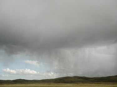 Approaching rain clouds on the Tibetan plateau in Qinghai province. The Tibetan plateau is known as the 'Third Pole', because it holds the largest store of fresh water outside the Antarctic and Arctic...