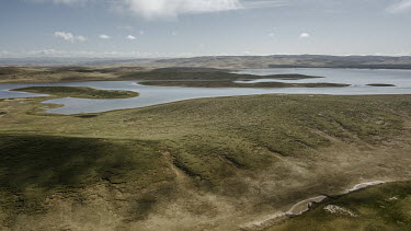 Grasslands between Gangagenacuo Lake and Rigecuo Lake. The cracked features of the grassland from this aerial view is a sign of melted permafrost, causing the frozen structure of the soil that support...