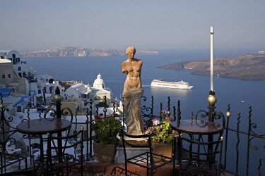 A statue on the terrace of a bar with views over the Mediterranean Sea.