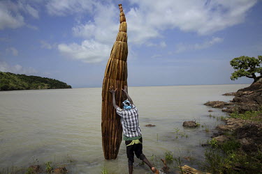 A fisherman launches his papyrus boat ('Tankwa') into Lake Tana.