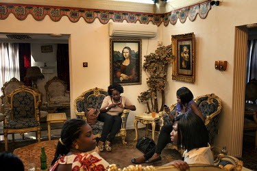 A 40th birthday party in the house of a wealthy Lagosian where one wall is decorated with a copy of the Mona Lisa. Among the city's rapidly increasing population of 21 million there is a growing middl...