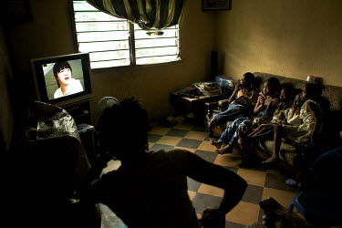 A group of children watch the television in an apartment on the Dolphin High Rise Estate, one of the city's growing middle class residential areas.