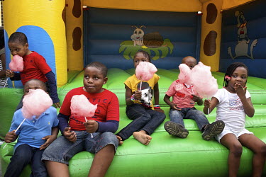 After playing on a bouncy castle, children eat candy floss during a party celebrating the first birthday of Tumi Abolarin at his parent's, Bimbo and Tomi's home in Agungi.