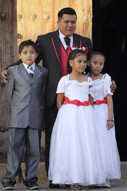 A page boy and bridesmaids at the marriage of an Indian couple at the Church of San Lazaro.