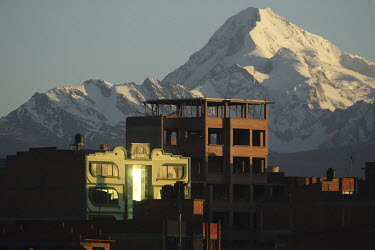'Cholet-style' buildings with the snow-covered Huayna Potosi mountain on the horizon. 'Cholet-style' buildings represent the new Indian architecture. The majority were built by the architect of Aymara...