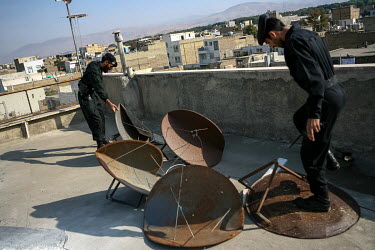 Police officers destroy satellite dishes taken from roofs in an attempt to block people from watching overseas Persian-language satellite channels. Millions of Iranians in possession of illegal satell...