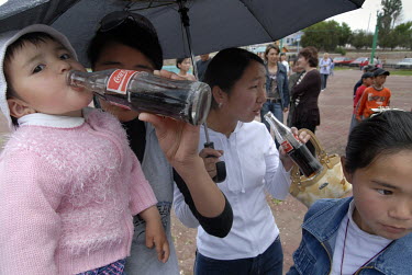 Children are given free Coca Cola during a promotion on 'Children's Day.