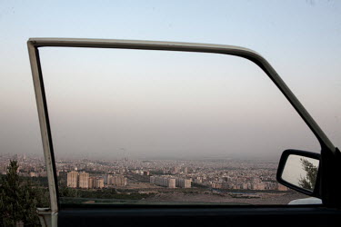 A view through the side window of a car over the capital.