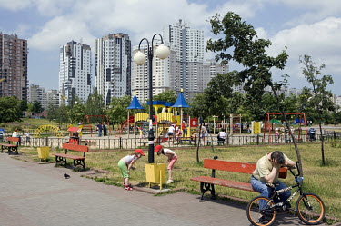 Children play in a residential district, where new blocks of flats are being constructed.
