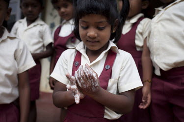V Maheshwary, the nursery school teacher on the Idulgashinna tea estate, shows her class how to wash their hands and teaches them the importance of hygiene.