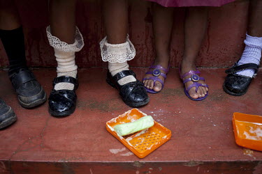 Nursery school children, on the Idulgashinna tea estate, wash their hands as they learn the importance of hygiene.