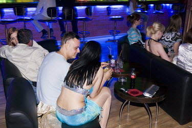 A striptease dancer talks with a man in the Premier nightclub. (Prior to the 2014 Russian occupation)