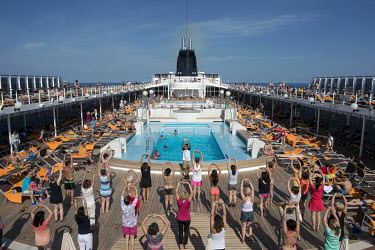 Passengers take part in a morning aerobics class onboard of the MSC Lirica, a cruise ship belonging to the Mediterranean Shipping Company.