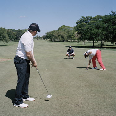 Members of Club Centenario, the most exclusive in Asuncion, play golf during their weekly visit. According to one of the workers at the club, the vast majority of members are part of the country's agr...
