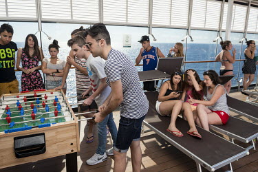 Young passengers play a game of table football onboard the MSC Lirica, a cruise ship belonging to the Mediterranean Shipping Company.