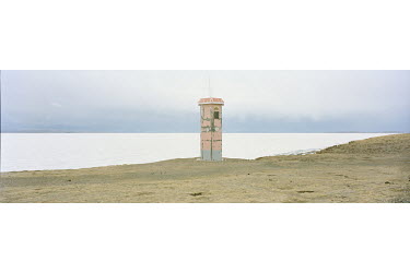 A viewing tower beside the Ngoring Lake in the Sanjiangyuan National Nature Reserve. A viewing tower on the frozen banks of Ngoring Lake rises above China's highest wetlands ecosystem. The lakes, glac...