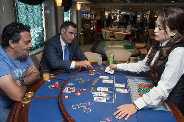 Passengers play a game of poker in the casino onboard the MSC Lirica, a cruise ship belonging to the Mediterranean Shipping Company.
