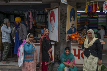 Women outside a clothing shop in the city bazaar.