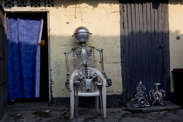 A model of a robot made by artist, Bienvenu Nanga, in the courtyard of his home. Nanga makes imaginary works, like robots, with recycled materials. He has had exhibitions in Kinshasa and also in Belgi...