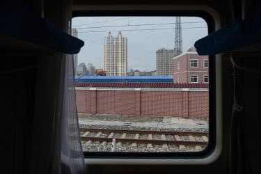 Dandong, seen through a window of the K27 international express train travelling from Beijing to Pyongyang.